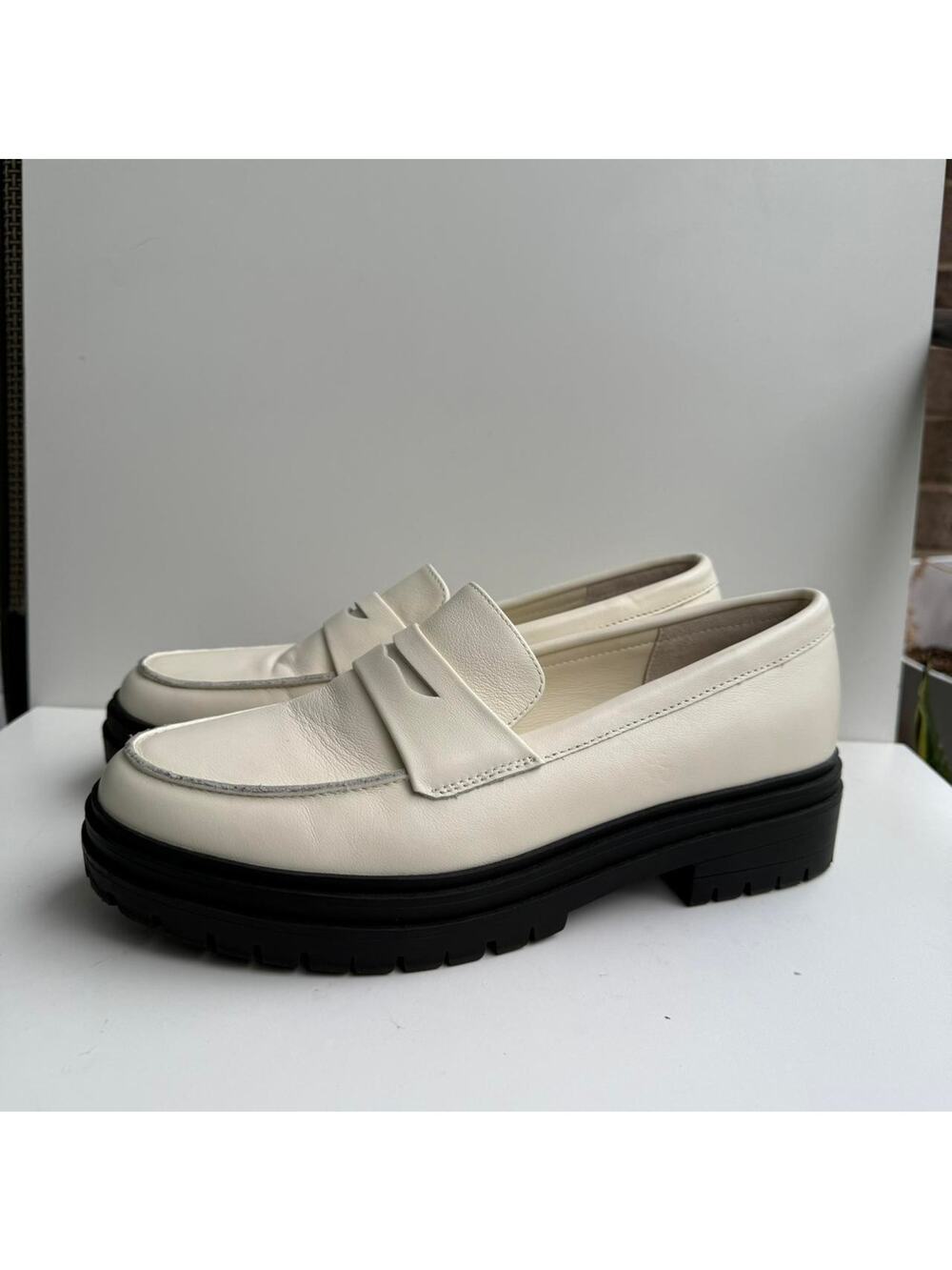White leather loafers with black